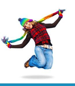 A girl jumping in the air with her arms outstretched.