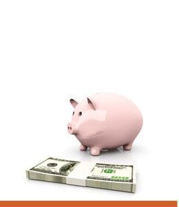 A pink piggy bank sitting on top of a pile of money.