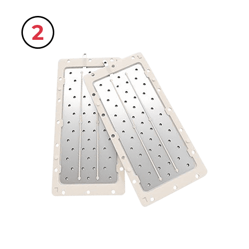 A pair of white plastic trays with holes in them.