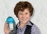 A boy holding a bottle of water in his hand.
